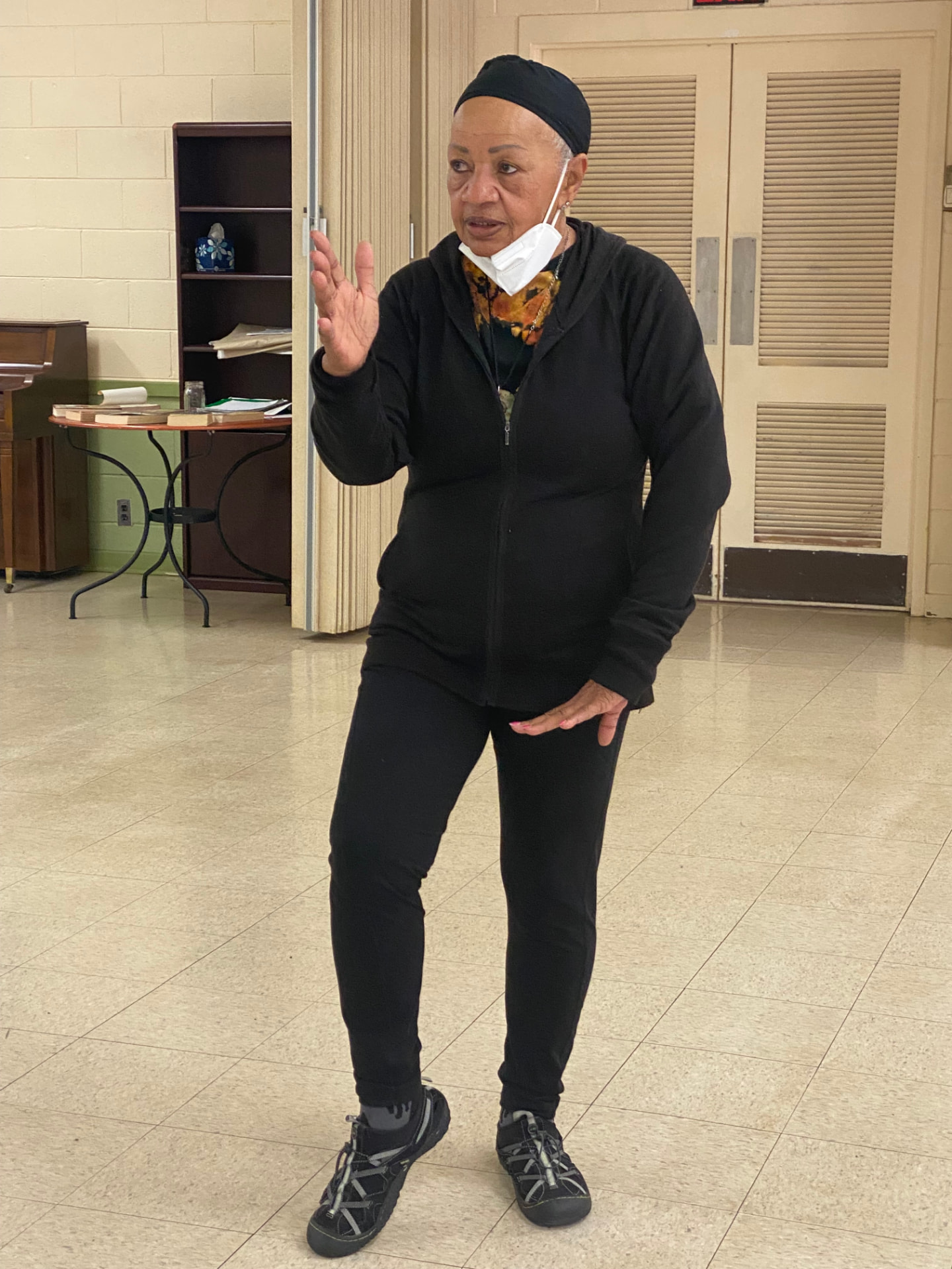 Ms. Ruth DeRamus mid-instruction, one hand raised, speaking to the class